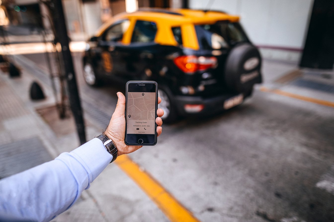 Man holding mobile GPS app to track location